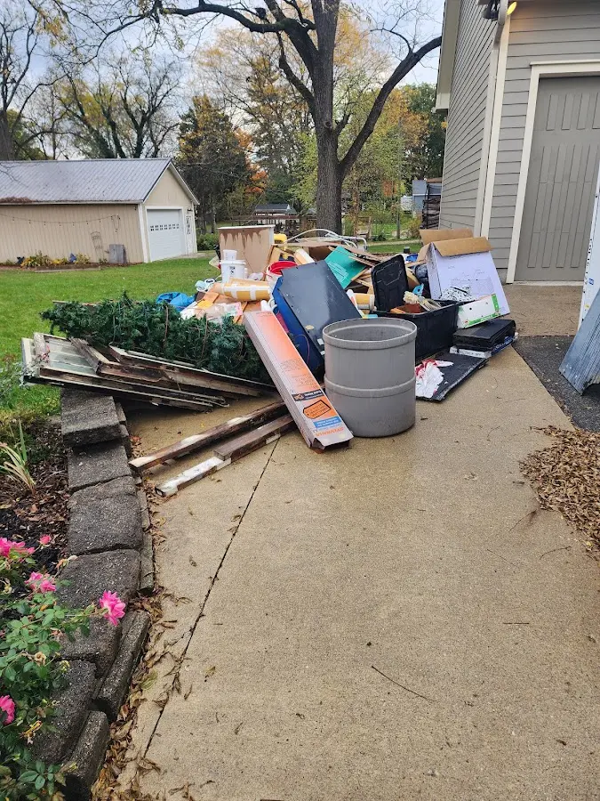 Dumpster being loaded with debris for Estate Cleanout Dumpster Rental in Marcy